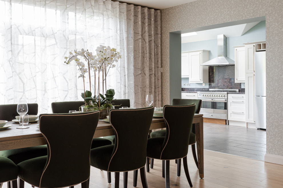 Inspiration for a contemporary dining room in Belfast with grey walls, light hardwood floors, beige floor and wallpaper.