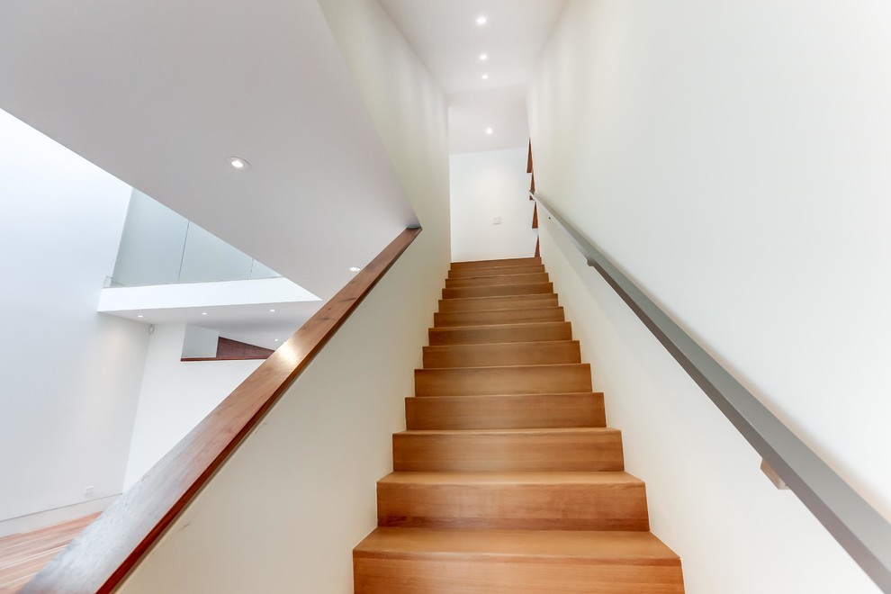 Mid-sized modern wood straight staircase in Toronto with wood risers.