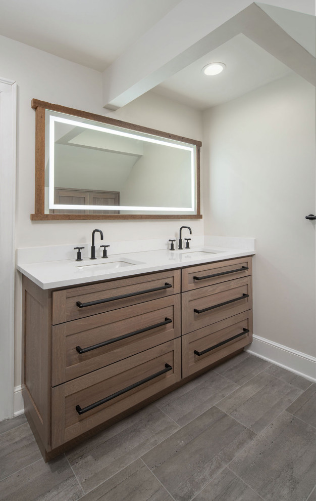 Example of a large transitional master porcelain tile, white floor and double-sink bathroom design in Columbus with shaker cabinets, medium tone wood cabinets, white walls, an undermount sink, quartz countertops, white countertops and a built-in vanity