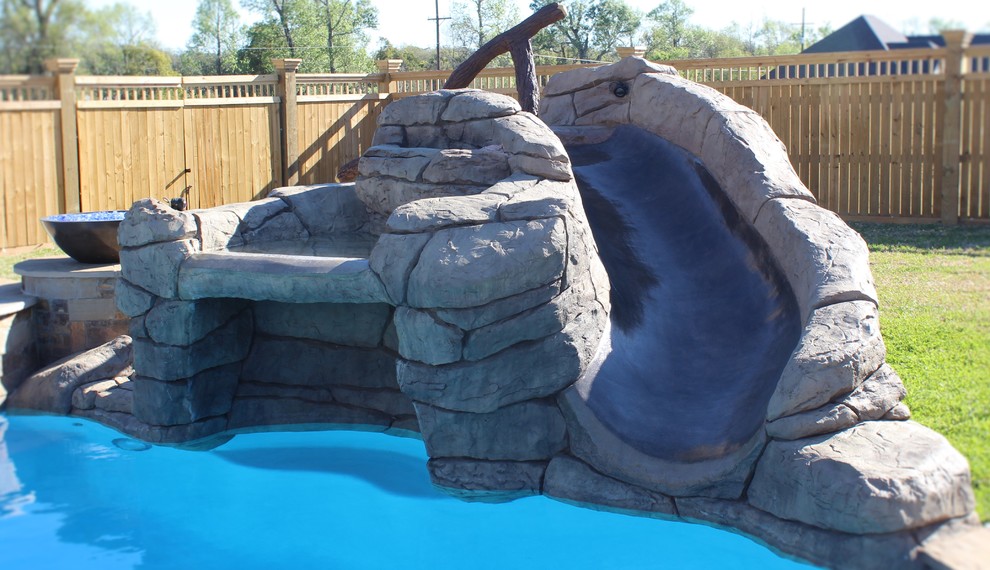 Photo of a mid-sized country backyard kidney-shaped natural pool in Houston with a water slide.