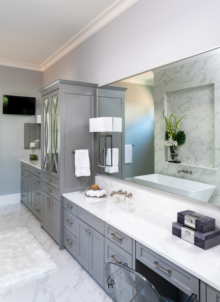 Freestanding bathtub - huge transitional master white tile and porcelain tile porcelain tile, white floor and double-sink freestanding bathtub idea with shaker cabinets, gray cabinets, a one-piece toilet, gray walls, an undermount sink, marble countertops, a hinged shower door, white countertops and a built-in vanity