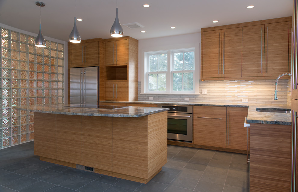 Inspiration for a contemporary l-shaped eat-in kitchen in Portland with an undermount sink, flat-panel cabinets, medium wood cabinets, granite benchtops, white splashback, glass tile splashback, stainless steel appliances, porcelain floors and with island.