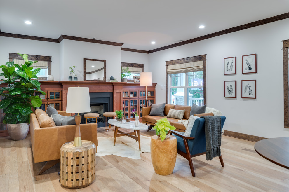Inspiration for a mid-sized transitional formal open concept living room in Providence with white walls, light hardwood floors, a standard fireplace, a metal fireplace surround, no tv and beige floor.