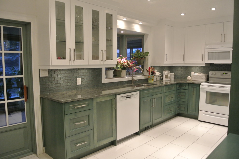 Design ideas for a mid-sized tropical u-shaped eat-in kitchen in Other with an undermount sink, shaker cabinets, green cabinets, granite benchtops, green splashback, glass tile splashback, white appliances, ceramic floors and no island.