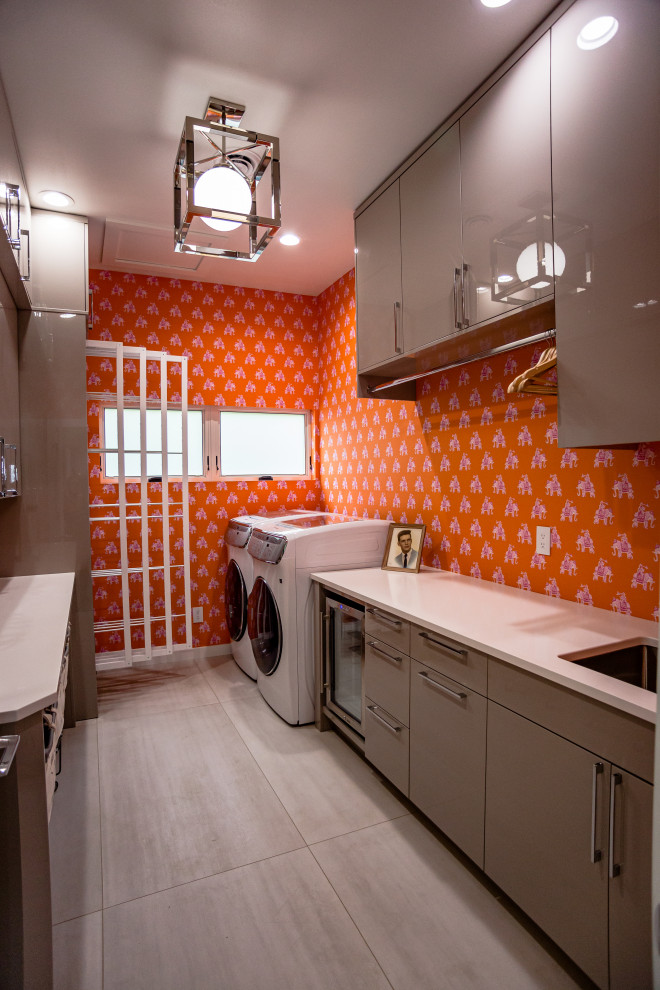 Inspiration for a large modern galley utility room in Other with a drop-in sink, flat-panel cabinets, grey cabinets, granite benchtops, orange walls, ceramic floors, a side-by-side washer and dryer, white floor and white benchtop.