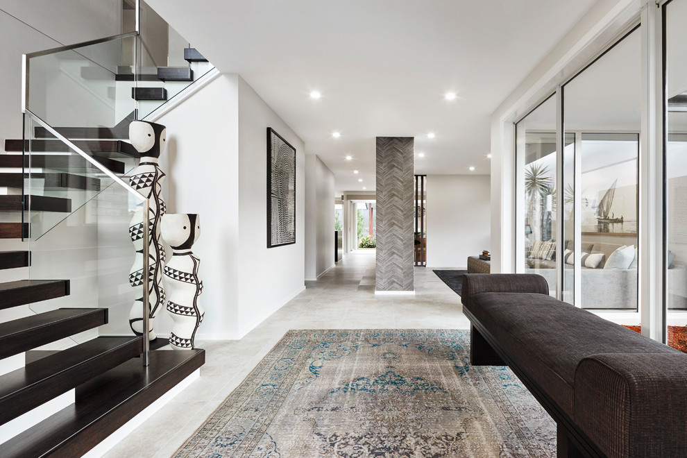 This is an example of a contemporary hallway in Sydney with white walls and grey floor.