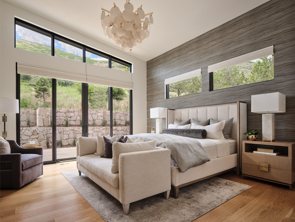 Inspiration for a large contemporary master bedroom in Denver with grey walls, light hardwood floors, beige floor, vaulted and wallpaper.