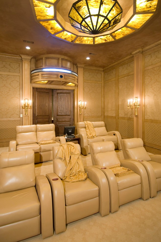 Inspiration for a mediterranean enclosed home theatre in Houston with beige walls, carpet, beige floor and a projector screen.