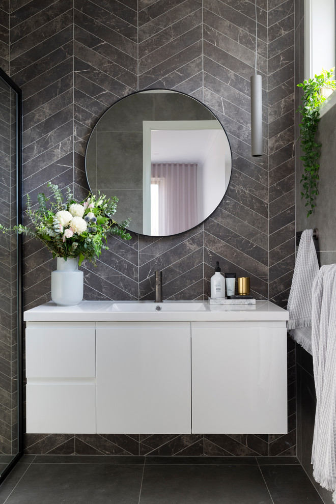 Design ideas for a mid-sized contemporary bathroom in Canberra - Queanbeyan with white cabinets, gray tile, porcelain tile, porcelain floors, an integrated sink, grey floor, flat-panel cabinets and white benchtops.