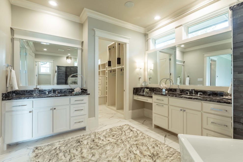 Inspiration for a large transitional master bathroom in Dallas with raised-panel cabinets, white cabinets, a freestanding tub, an alcove shower, a bidet, black tile, slate, grey walls, porcelain floors, an undermount sink, granite benchtops, white floor, an open shower and black benchtops.
