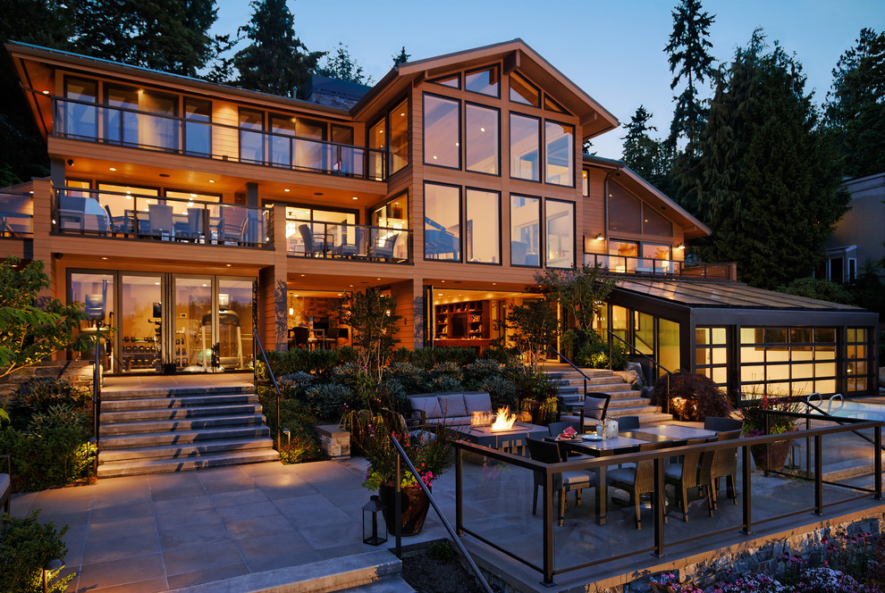 Design ideas for an expansive contemporary three-storey brown house exterior in Seattle with wood siding and a gable roof.