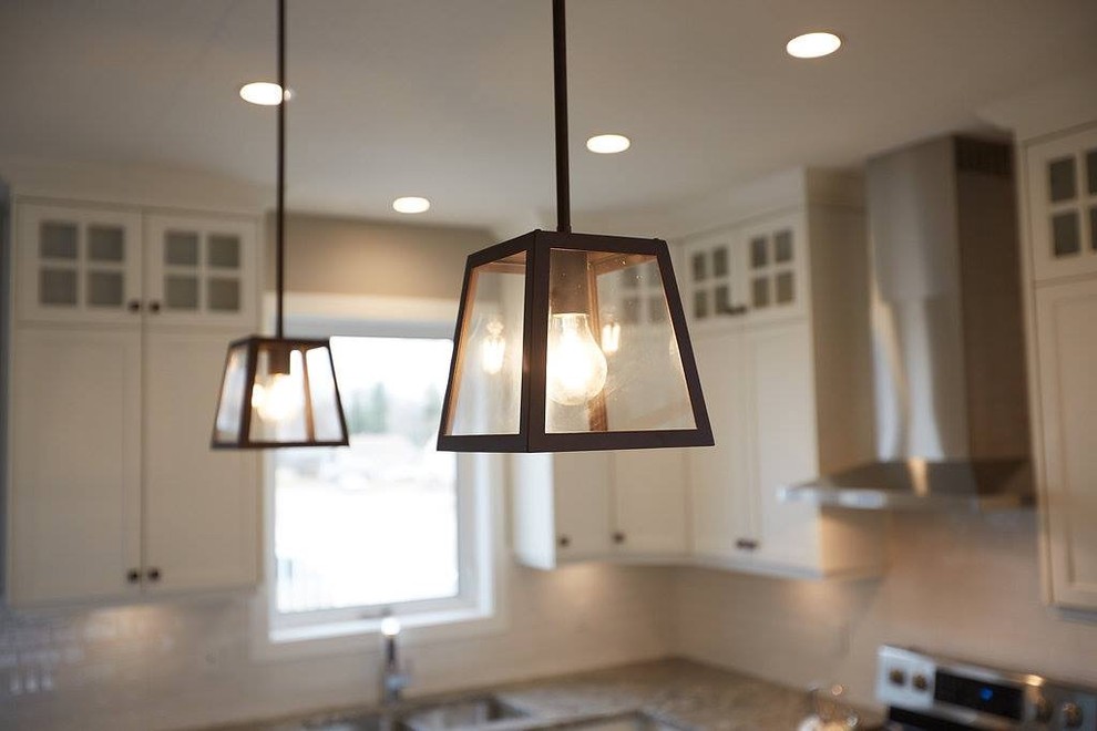 Kitchen - mid-sized transitional l-shaped kitchen idea with a double-bowl sink, shaker cabinets, white cabinets, granite countertops, white backsplash and subway tile backsplash