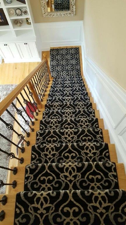 This is an example of a transitional wood straight staircase in New York with painted wood risers.