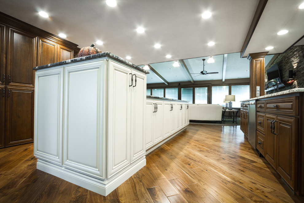 Example of a large transitional l-shaped eat-in kitchen design with two islands