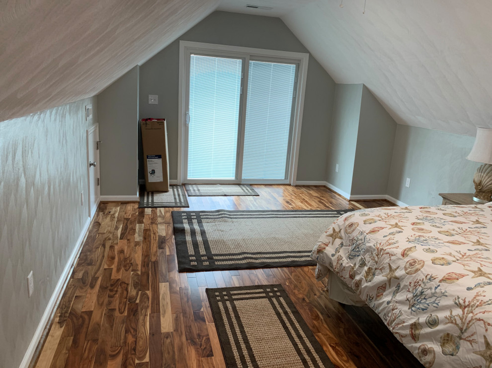 Bedroom - large contemporary guest dark wood floor, brown floor and vaulted ceiling bedroom idea with gray walls
