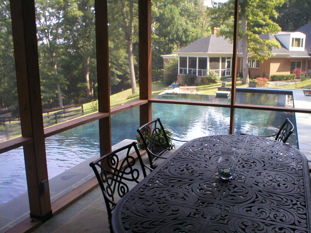 Inspiration for a large rustic backyard stone and custom-shaped infinity pool remodel in DC Metro