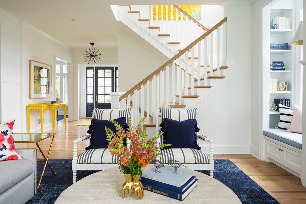 Family room - large coastal open concept light wood floor and brown floor family room idea in Minneapolis with white walls, a standard fireplace, a wood fireplace surround and a wall-mounted tv