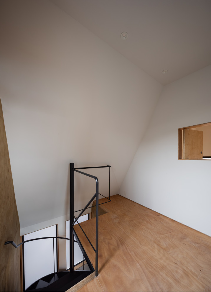 Example of a small trendy freestanding desk medium tone wood floor, brown floor, shiplap ceiling and wood wall study room design in Tokyo with brown walls