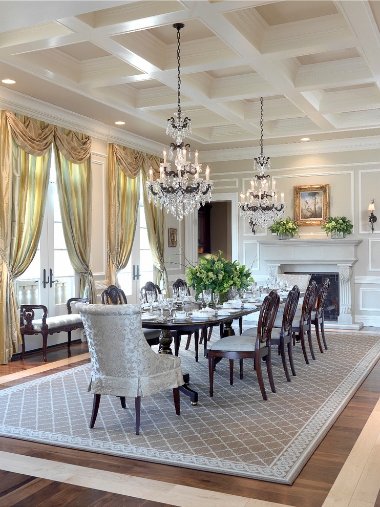 Inspiration for a traditional separate dining room in St Louis with beige walls, dark hardwood floors and a standard fireplace.