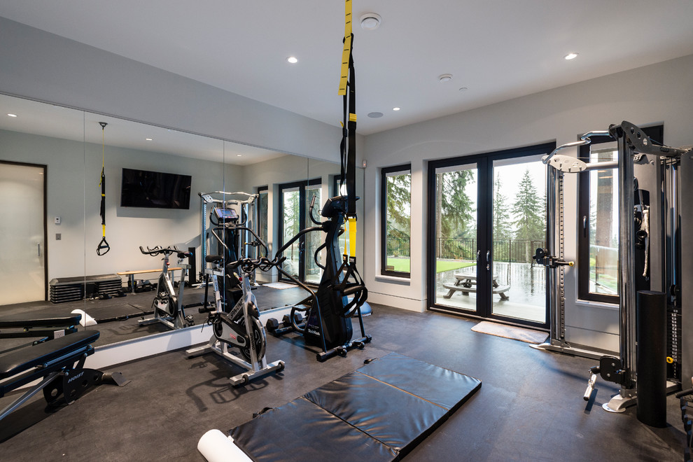 Expansive transitional home weight room in Vancouver with white walls, vinyl floors and black floor.