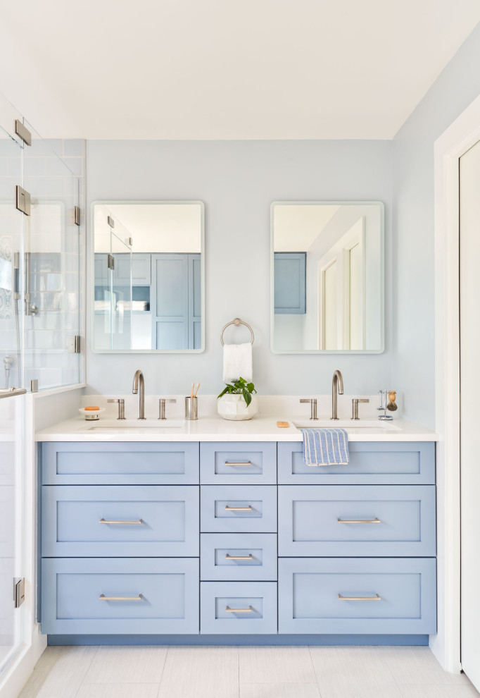 Medium sized contemporary ensuite bathroom in Austin with shaker cabinets, blue cabinets, a corner shower, blue tiles, blue walls, a submerged sink, a hinged door, white worktops, double sinks and a built in vanity unit.