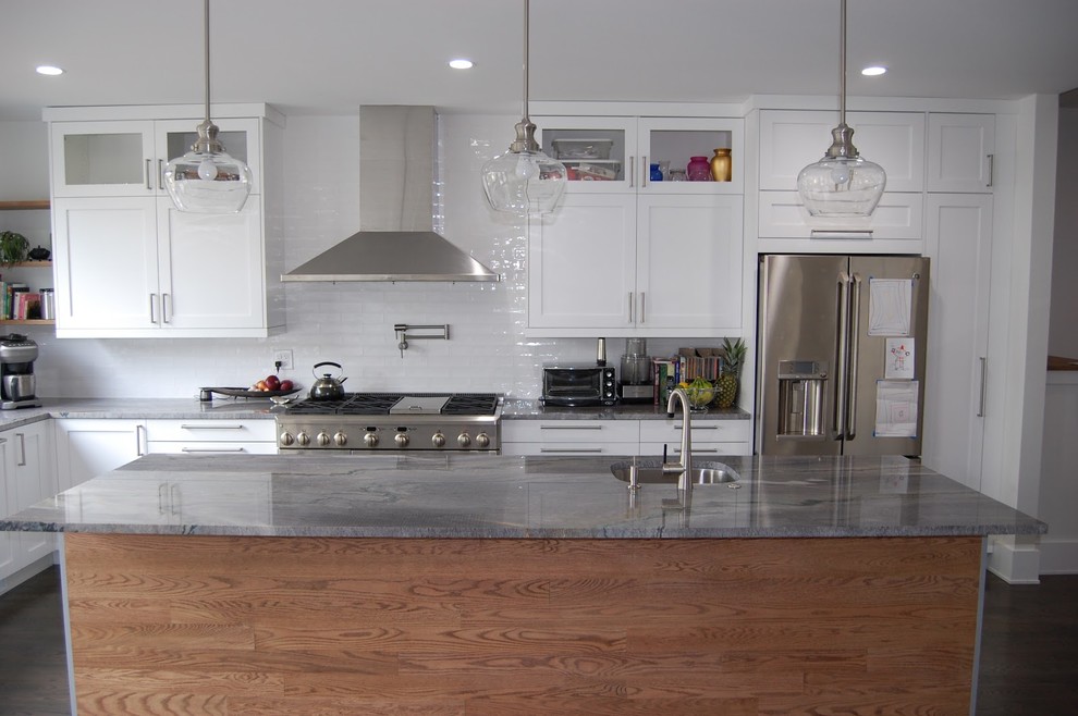 Design ideas for a large transitional l-shaped kitchen in San Francisco with an undermount sink, shaker cabinets, white cabinets, quartz benchtops, white splashback, subway tile splashback, stainless steel appliances, dark hardwood floors and with island.