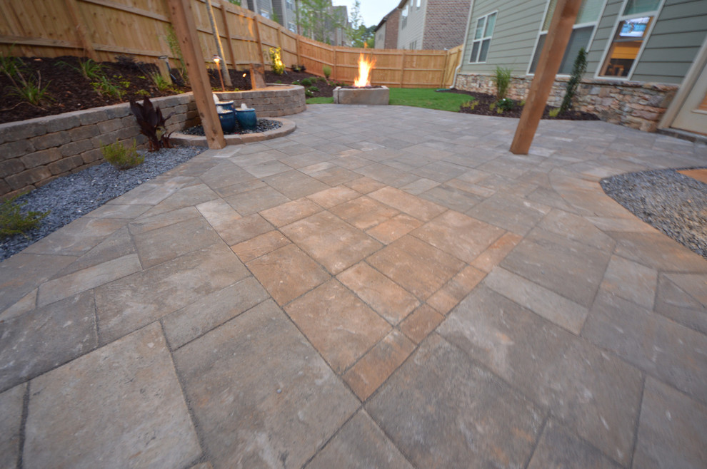 This is an example of a small modern backyard partial sun garden in Atlanta with a fire feature and natural stone pavers.