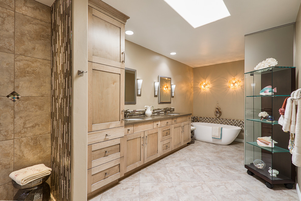 Inspiration for a large transitional master bathroom in Phoenix with shaker cabinets, light wood cabinets, brown tile, glass tile, beige walls, travertine floors, an undermount sink and engineered quartz benchtops.