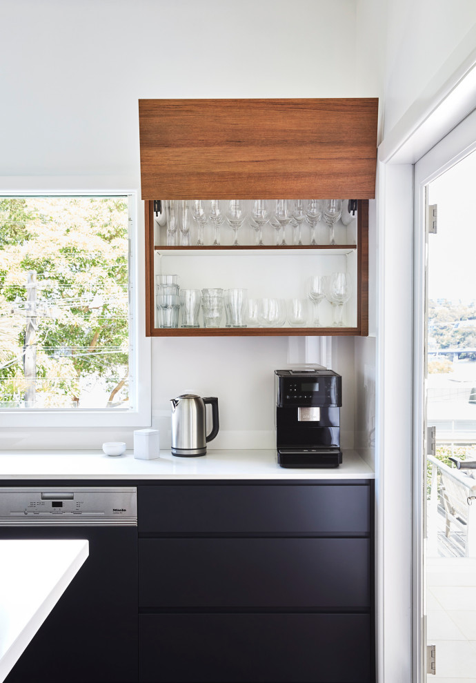 This is an example of a medium sized modern u-shaped enclosed kitchen in Sydney with a double-bowl sink, flat-panel cabinets, blue cabinets, engineered stone countertops, white splashback, engineered quartz splashback, dark hardwood flooring, an island, brown floors and white worktops.