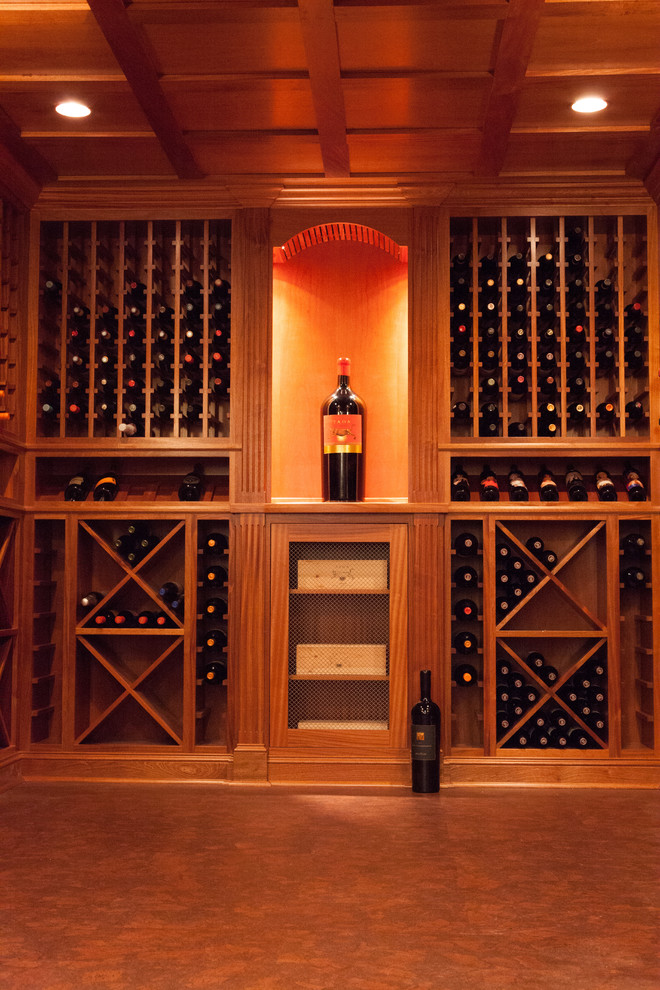 Inspiration for a large traditional wine cellar in Boston with cork floors, display racks and brown floor.