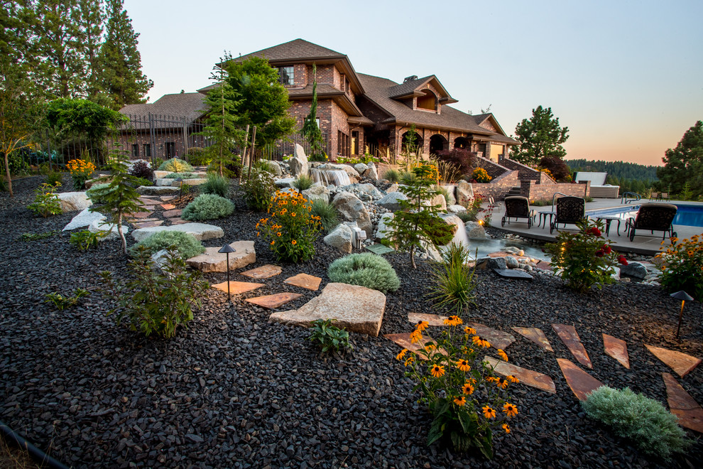 Inspiration for a large traditional backyard formal garden in Seattle with gravel and a garden path.