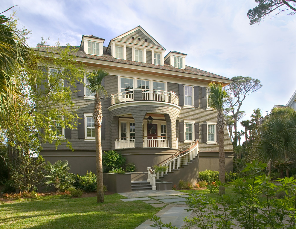 Inspiration for a traditional three-storey exterior in Charleston with wood siding and a hip roof.
