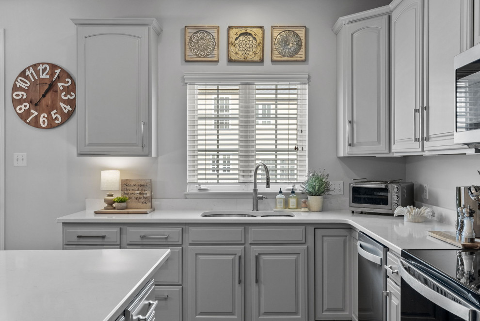 Inspiration for a transitional dark wood floor eat-in kitchen remodel with a double-bowl sink, gray cabinets, quartz countertops, stainless steel appliances, an island and white countertops