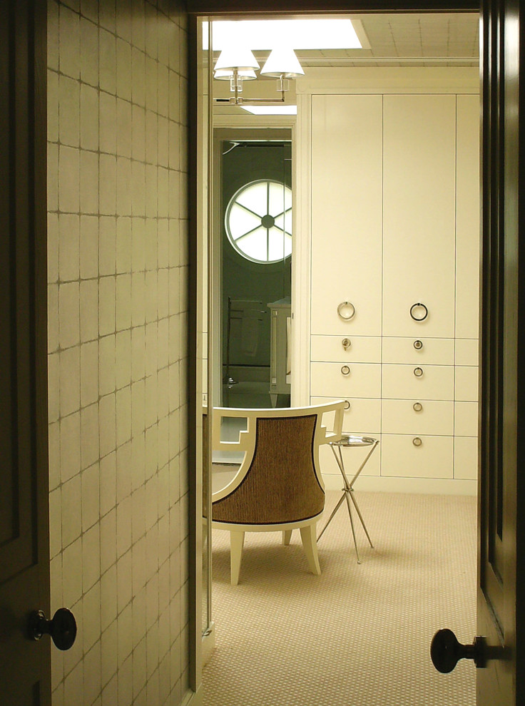 This is an example of a mid-sized contemporary women's dressing room in Philadelphia with flat-panel cabinets, white cabinets and carpet.