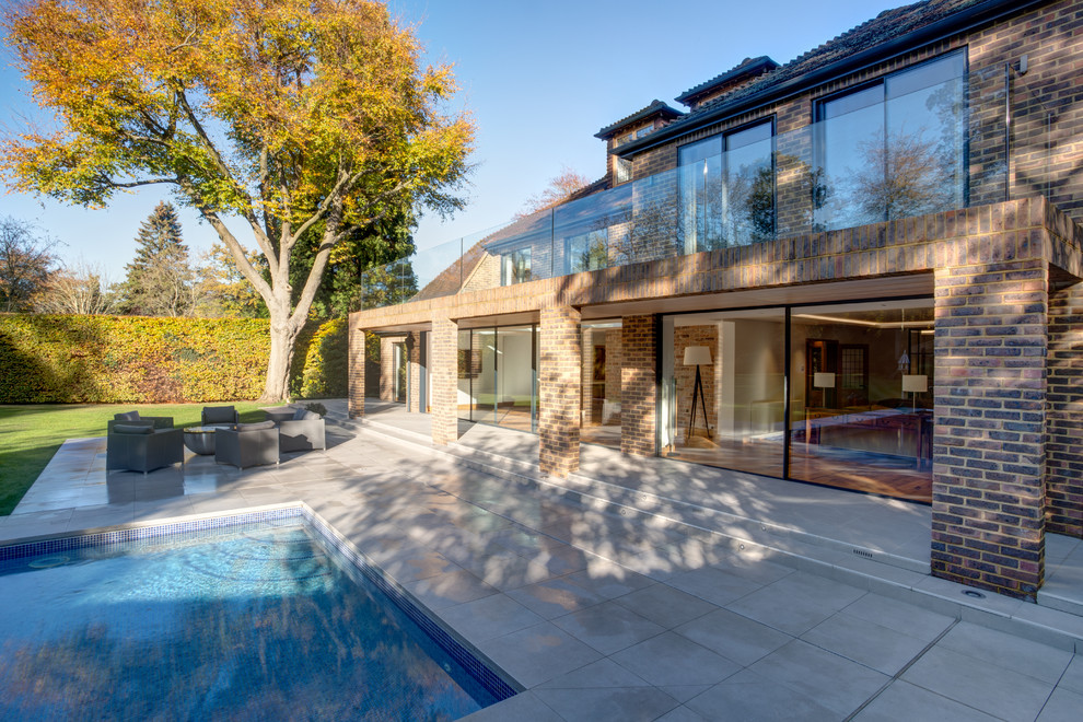 Inspiration for a contemporary brown house exterior in Surrey.