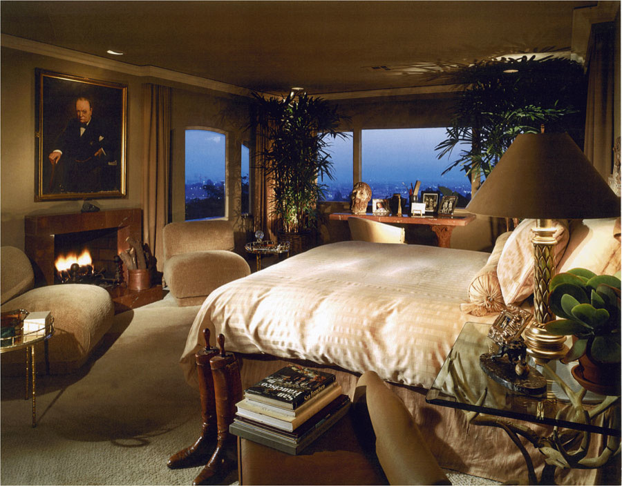 Photo of a large traditional master bedroom in Los Angeles with brown walls, carpet, no fireplace and brown floor.