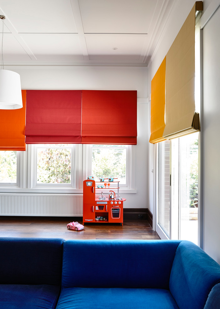 This is an example of a large contemporary gender-neutral kids' room in Melbourne with white walls and dark hardwood floors.