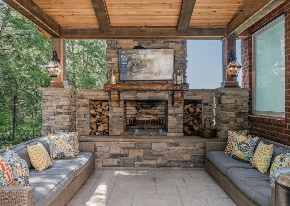 This is an example of a country patio in Nashville with a roof extension and with fireplace.