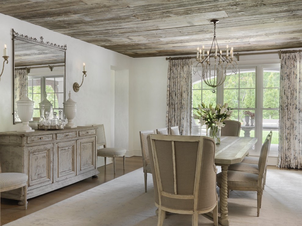 Design ideas for a country dining room in Other with white walls, medium hardwood floors and brown floor.