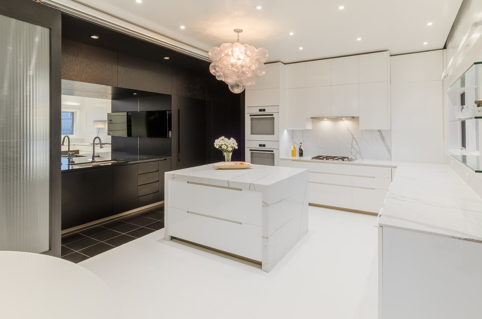 Photo of a mid-sized contemporary u-shaped eat-in kitchen in Other with an undermount sink, flat-panel cabinets, white appliances, painted wood floors, with island, white floor, black cabinets, white splashback and white benchtop.