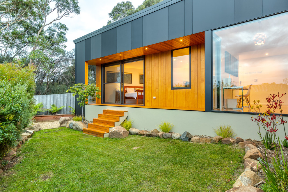 Mid-sized contemporary backyard deck in Hobart with a container garden and a roof extension.