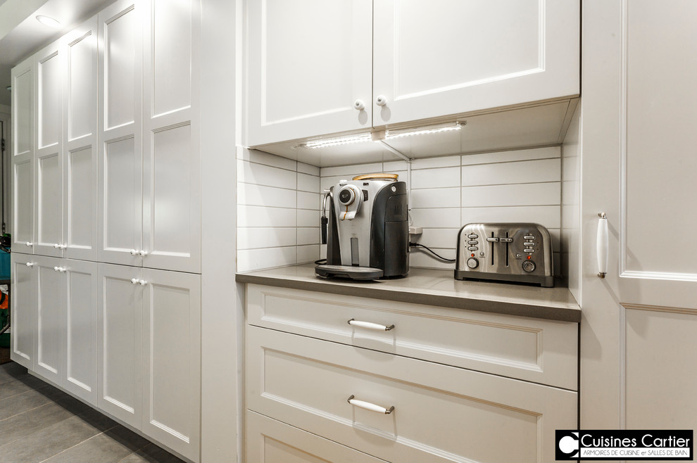 Large transitional medium tone wood floor eat-in kitchen photo in Montreal with a double-bowl sink, shaker cabinets, white cabinets, quartzite countertops, white backsplash, ceramic backsplash, stainless steel appliances and an island