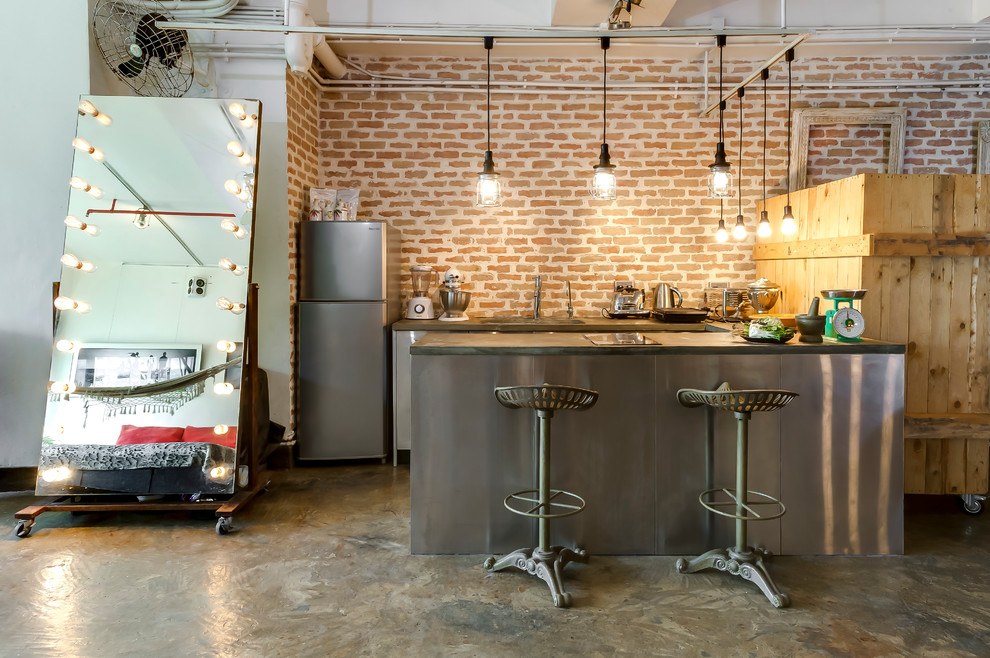 Inspiration for an industrial u-shaped open plan kitchen in Hong Kong with red splashback, brick splashback, stainless steel appliances and beige floor.