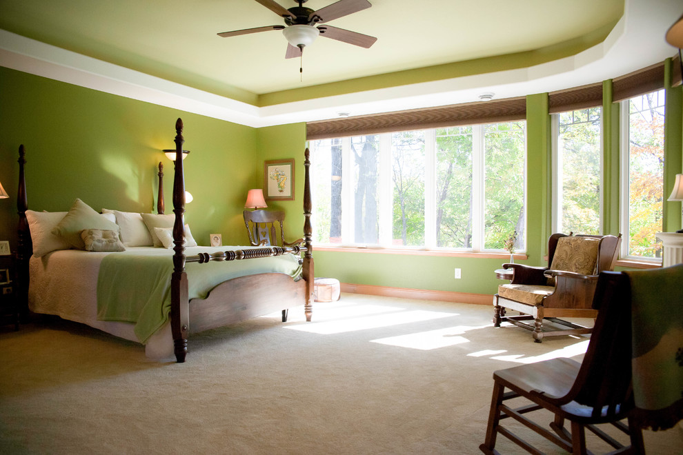 Photo of a large traditional master bedroom in Other with green walls, carpet, beige floor, a standard fireplace and a tile fireplace surround.