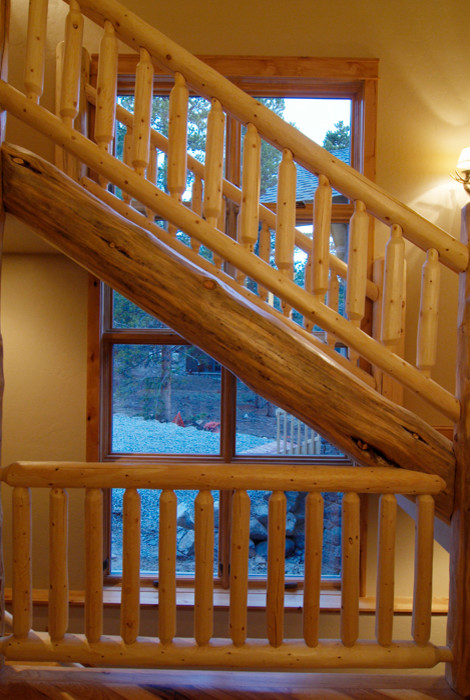 Staircase - large rustic wooden l-shaped open staircase idea in Denver