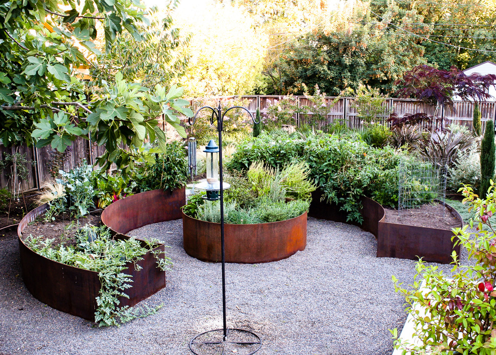 Design ideas for a large mediterranean partial sun backyard gravel vegetable garden landscape in Portland.