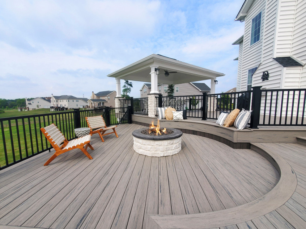 Mid-sized minimalist backyard second story metal railing deck photo in Other with a fire pit