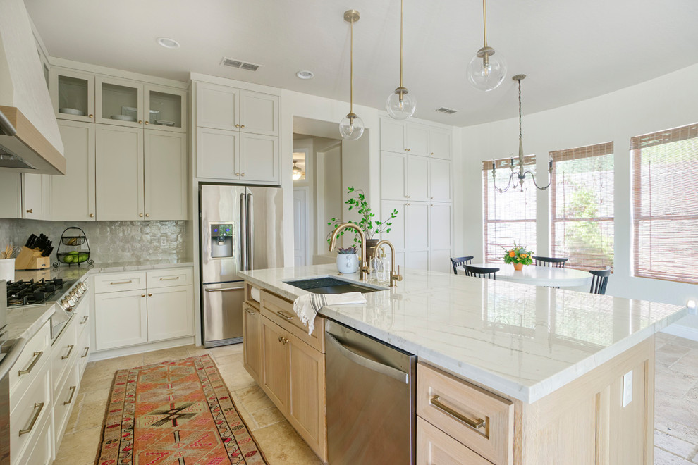Transitional limestone floor kitchen photo in Phoenix with light wood cabinets, quartzite countertops and an island