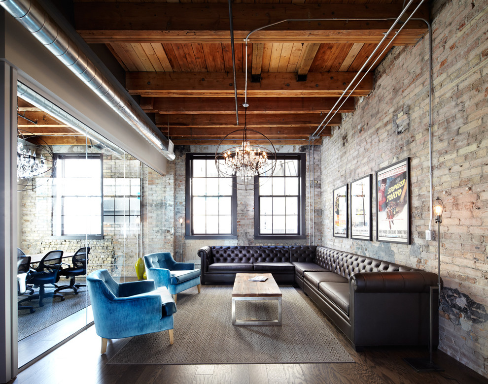 This is an example of a large industrial living room in Dallas with dark hardwood floors.