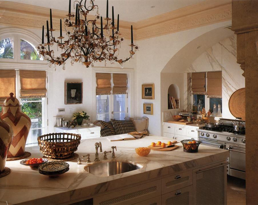 Inspiration for a large eclectic l-shaped eat-in kitchen in Phoenix with an undermount sink, recessed-panel cabinets, white cabinets, marble benchtops, stone slab splashback, stainless steel appliances, travertine floors and with island.